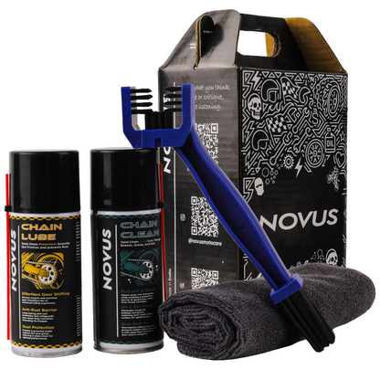 Novus chain maintenance kit with chain lube, cleaner, brush, and cloth on a white background